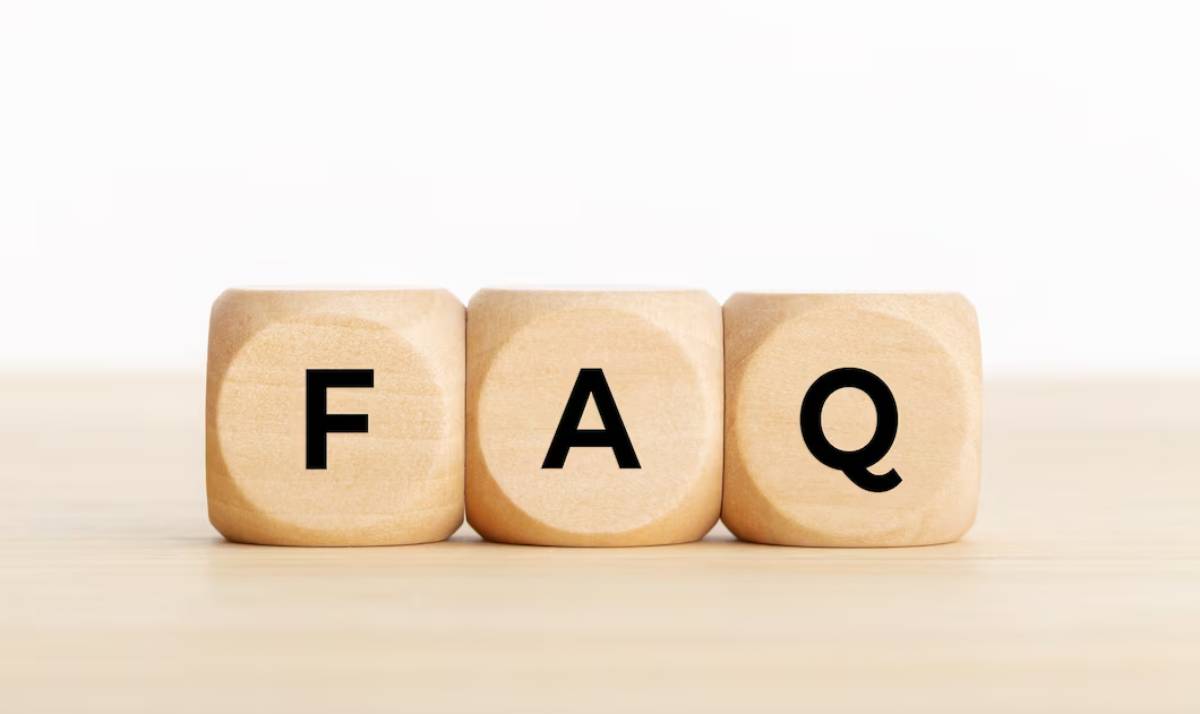 Three wooden blocks on a desk spelling FAQ.