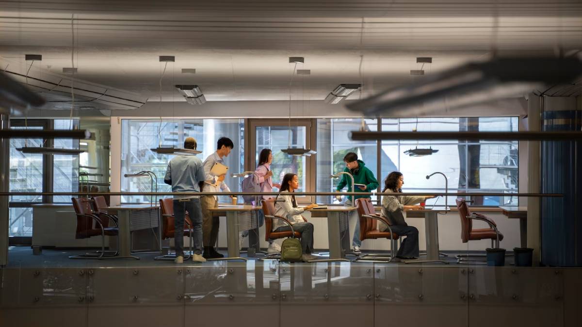 Students work and interact in a modern, well-lit university science laboratory.