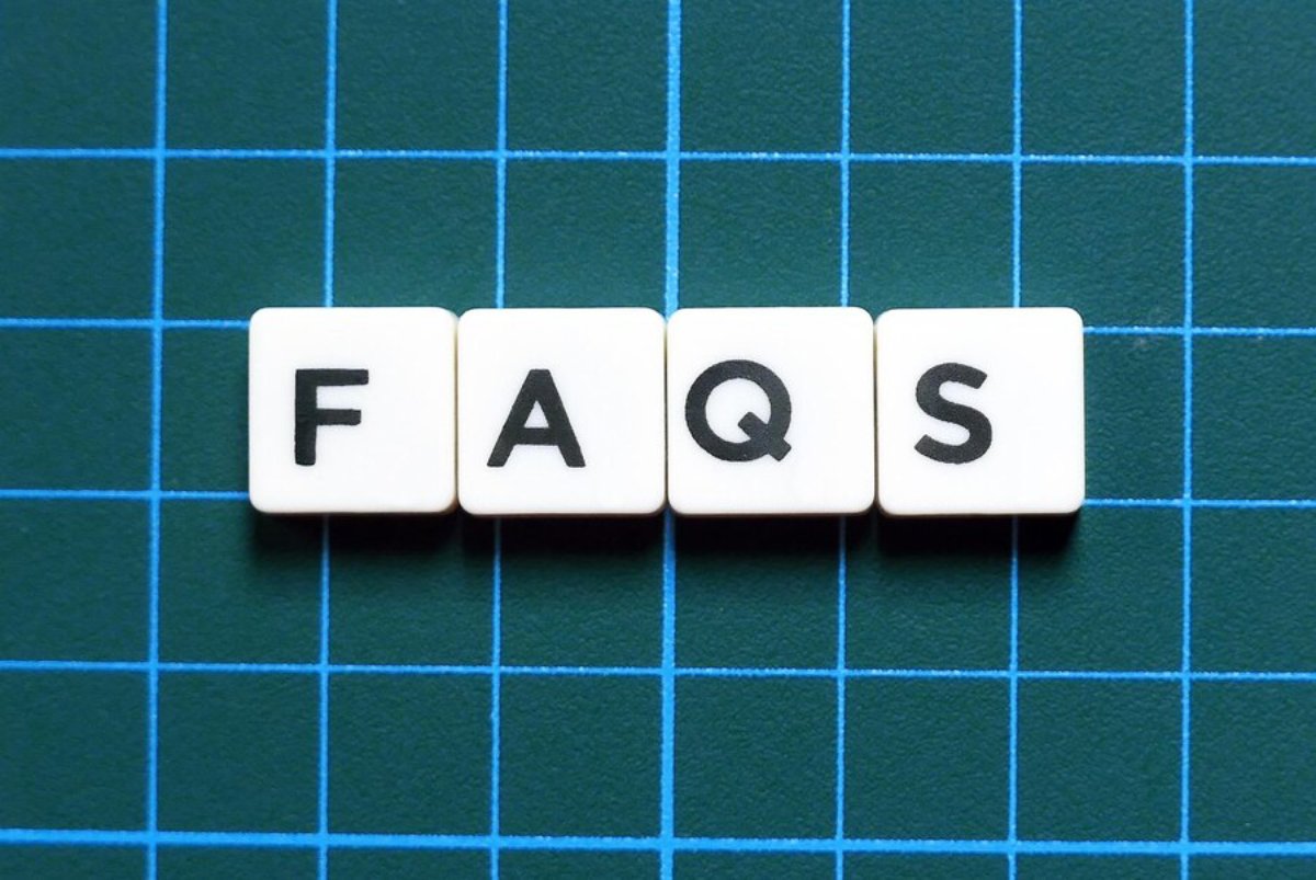 Scrabble tiles spelling FAQS on a blue grid background.